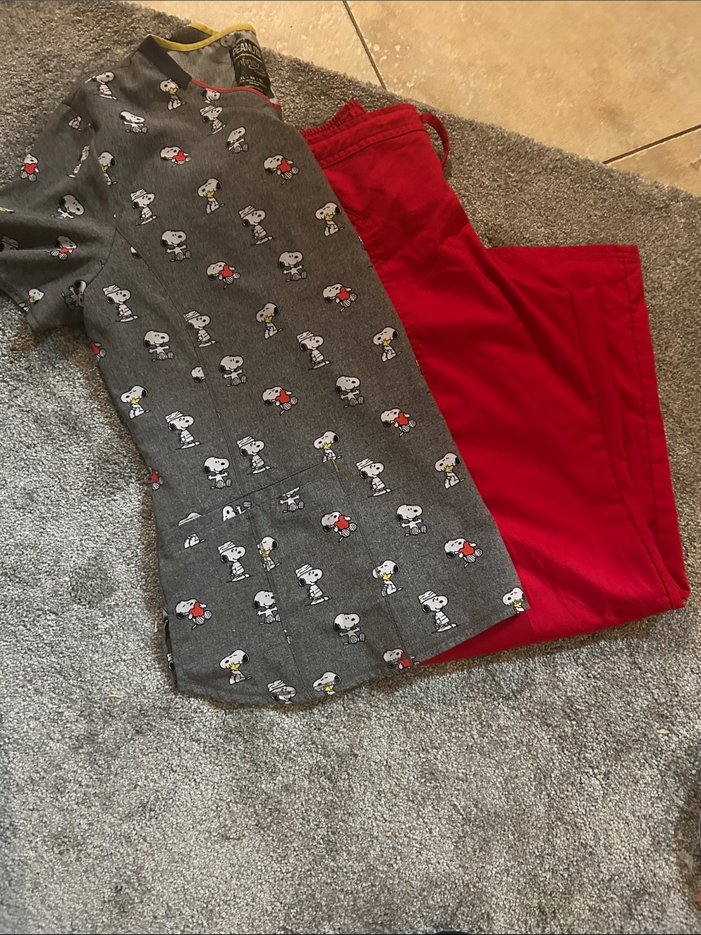 Snoopy scrub top and red scrub bottoms